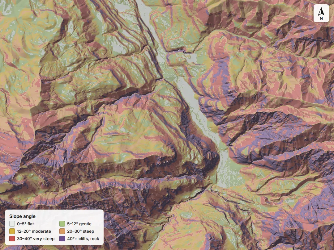 A Unit 65 drainage colored by slope angle: pale on the valley floor, yellow-green on gentle shelves, orange and red on the steep faces, purple on cliffs.